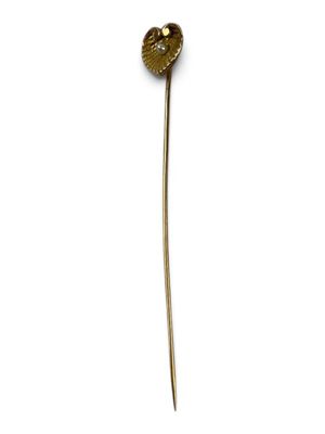 a close up of a stick with a heart shaped object on it