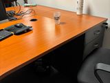 a desk with a computer on it and a chair in front of it