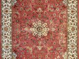 a red rug with a floral design on it