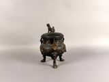 an antique bronze incense pot with a dog on top
