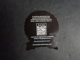 a sticker with a qr code on it sitting on a table