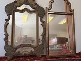 two mirrors that are sitting on a table