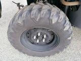 a large tire on the back of a four - wheeler