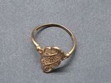 a close up of a gold ring with a skull on it