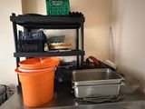 une photo d'une cuisine avec une cuisinière, un évier et des étagères