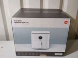 packaging of a white box with a black and white image of a small air purifier