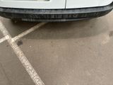 a white truck parked in a parking lot with no one on it