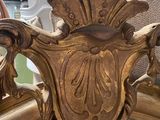 a mirror that has a gold frame on top of it