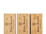 three wooden boxes with different types of wine on them
