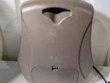 a brown toilet paper dispenser sitting on a white counter
