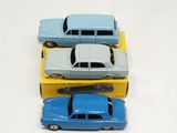 three toy cars sitting on top of each other on a table