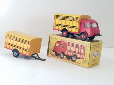 two toy trucks sitting next to each other on a white surface
