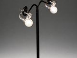 a pair of black and white lamps on a black metal pole