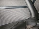 a close up of a car seat with a black leather trim