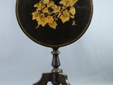 an image of a black and gold table with flowers on it