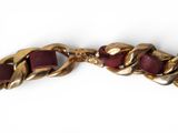 gold chain bracelet with a red stone clasp