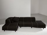 an image of a black sectional sofa in a white room