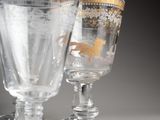 two wine glasses sitting next to each other on a table
