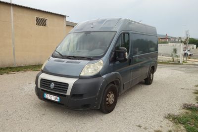 a van parked in a parking lot with a building in the background