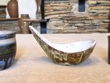 two bowls and a cup on a table in a living room