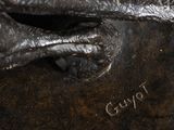 a close up of a statue of a bird on a table