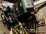 a pile of junk on the ground next to a pile of tools