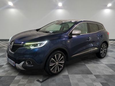 a blue car parked in a room with a checkered floor