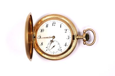a gold pocket watch on a white surface with a key