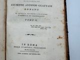 an old book opened on a white surface