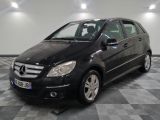 a picture of a black mercedes b - class parked on a checkered floor