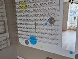many glasses on display in a store with a mirror