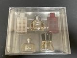 a clear box containing a bottle of perfume and a bottle of cologne