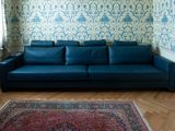 an image of a living room with a blue couch