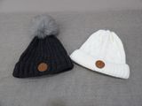 two hats with buttons on them are sitting on a bed