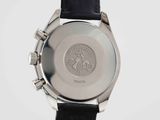 a close up of a watch on a white surface with a black strap