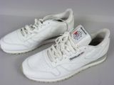 pair of white sneakers with red and blue logos on them