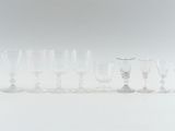 many wine glasses lined up in a row