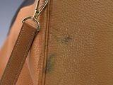 a brown bag with a brown handle on it