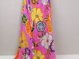 a pink and yellow floral dress hanging on a hanger