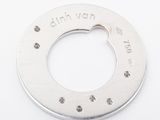 a metal ring with a hole in it on a white surface