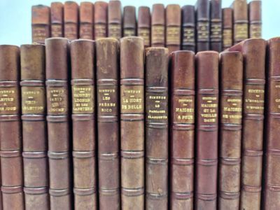 many old books lined up together on a shelf