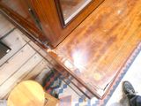 a person standing in front of a wooden cabinet