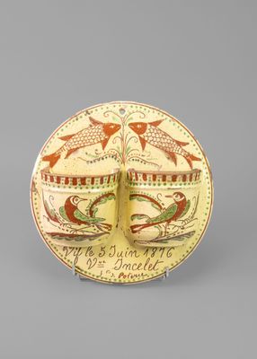 an image of a decorative plate with a bird and fish design