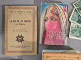 many old books on the table with pictures on them