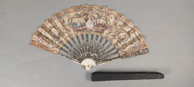 a fan and a knife on a table next to each other