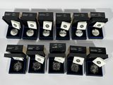 six silver coins are in a black box on a white surface
