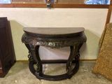 a small table that is sitting in front of a window