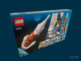 a box of legos with a space rocket in it