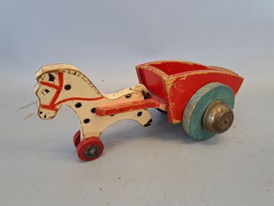 a small wooden toy horse pulling a cart