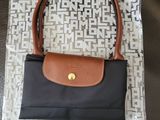 a black and brown purse sitting on top of a bag